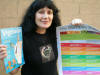 Tired but gratified Rina at home, after event, with Rainbow Poster and Veg Starter Kit